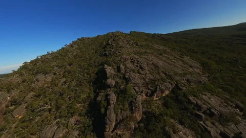 Flying on an FPV drone over the top of a cliff Stock Footage 244930009