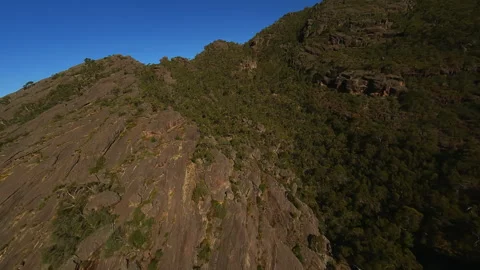 Flying on an FPV drone over the top of a cliff Stock Footage 244930171