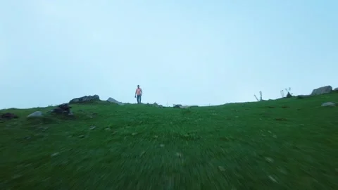 Flying Fpv shot of a man walking on a mountain Video stock 252072282