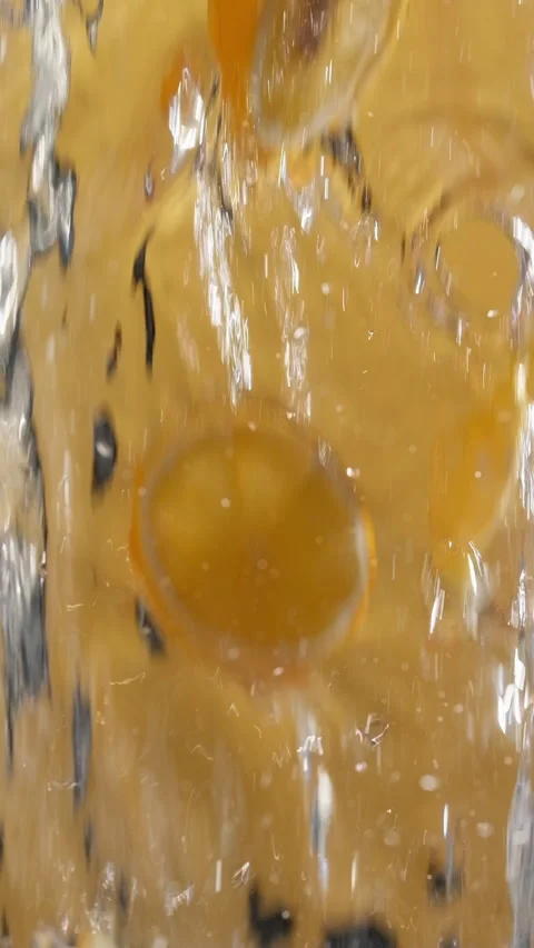 Flying fresh sliced lemon with water on yellow background. Slow motion Stock Footage 314133138
