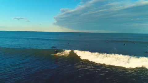 Flying in front of surfer at sunset. Surfing on big wave , aerial 4k Stock Footage 85625861