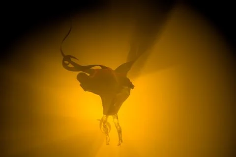 Flying Ghost boy figure covered with a black blanket sheet on dark Background Illustrazione stock