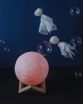 Flying ghosts in soap bubbles over the moon Stock Photos