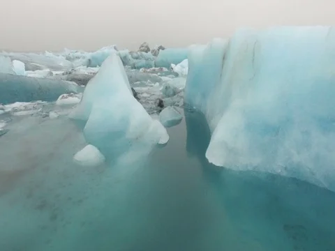 Flying by Glaciers floating in the water Stock Footage 75890786