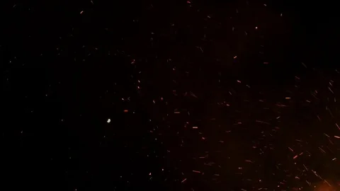Flying glowing bonfire embers into night sky Stock Footage