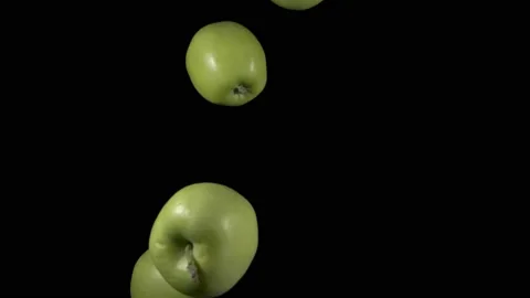 Flying green apples on a black background. Organic fruits. Stock Footage 148776154