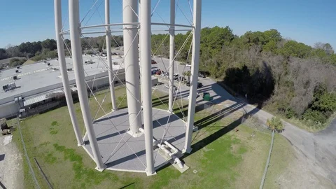 Flying from ground level slowly up the water tower to the top and revolving Stock-Footage 90562861