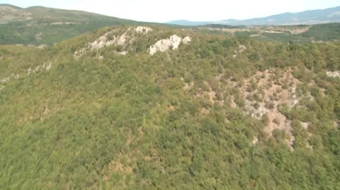 Flying in helicopter over hill forest hill Stock Footage 8693470