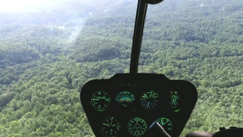 Flying a helicopter over mountains Видео 73806626