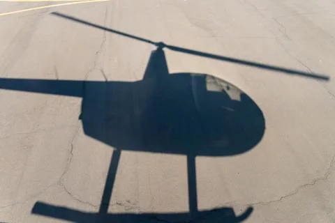 Flying helicopter shadow Stock Photos