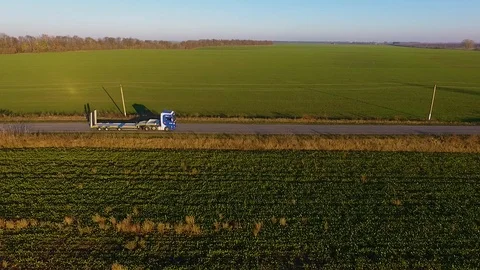 Flying high above freight semi truck transporting goods on busy highway across Video stock 99805118