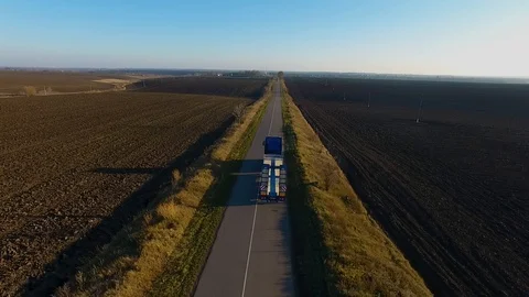 Flying high above freight semi truck transporting goods on busy highway across Video stock 99805193