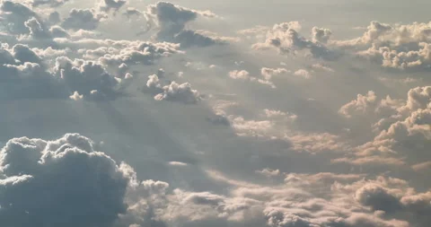 Flying high above gray cloudscape backlit by sun rays, view from cockpit plane Stock Footage 158670541