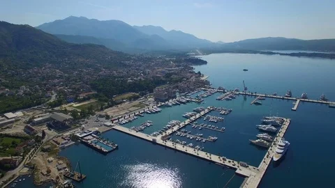 Flying high above luxury harbor with yachts, boats and pier. Stock Footage 78005850