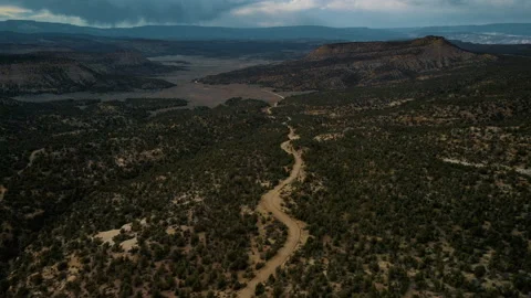 Flying high above a remote desert road Stock Footage 157436673