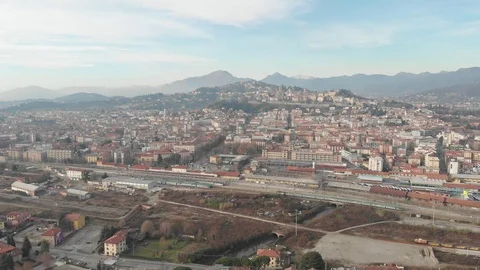 Flying high above the train station of the city of Bergamo, Lombardy  in Italy Stock Footage 100470369