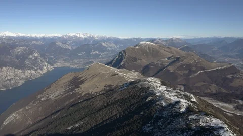 Flying high along mountain ridge in Italian Alps, Lake Garda Stock Footage 102498030