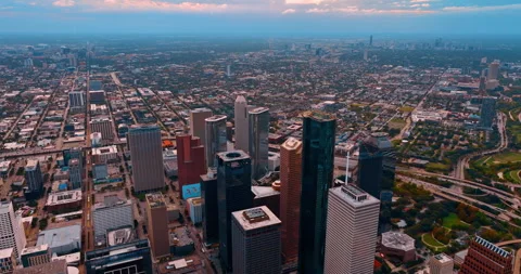 Flying high over the rooftops of downtown Houston, Texas, USA at sundown. Misty Stock Footage 323308385