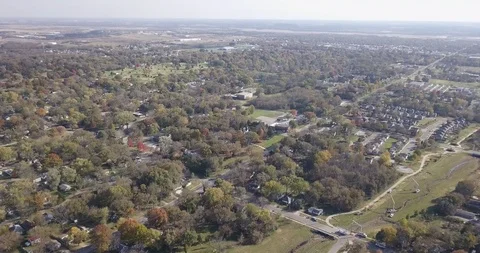 Flying High over Small Town Suburbs in Fall Stock Footage 119449494