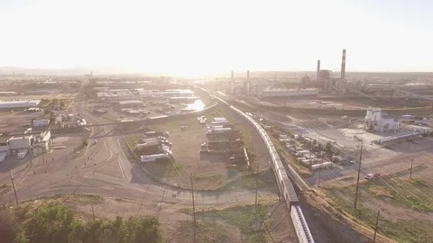 Flying high over train towards industrial zone Stock Footage 98845235