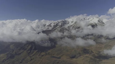 Flying high through the clouds to reveal mountains Video stock 82832119