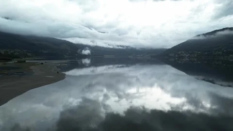 Flying hyperlapse of clouds and reflective lake Stock Footage 252257363