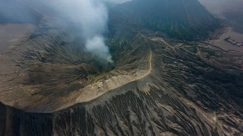 Flying inside the active mouth of the volcano FPV drone Video stock 275339633