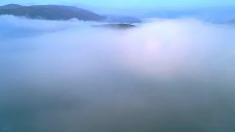 Flying inside the clouds above mountain tops. High peaks wonderful morning Stock Footage 98315161
