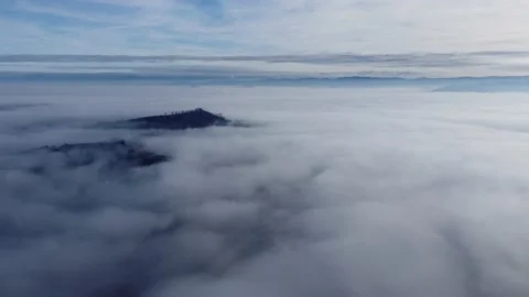 Flying to an island in a sea of clouds. Stock Footage 168005223