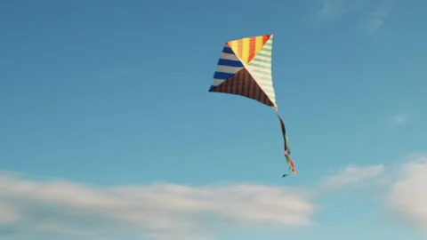 Flying kite against background blue sky at sunset on sunny day in summer Stock Footage 140260374