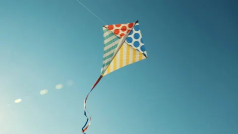 Flying kite against background blue sky at sunset on sunny day in summer Stock Footage 141876772