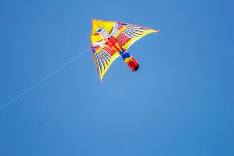 Flying kite in blue sky Stock Photos