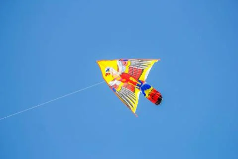Flying kite in blue sky Stock Photos