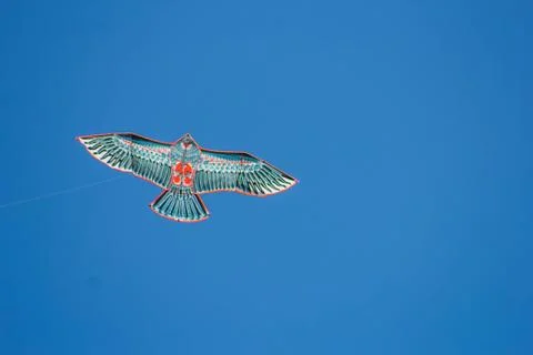 Flying kite in blue sky Stock Photos
