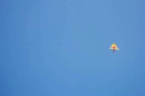 Flying kite in blue sky Stock Photos