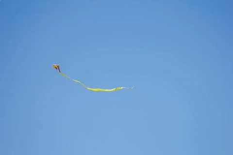 Flying kite in blue sky Stock Photos