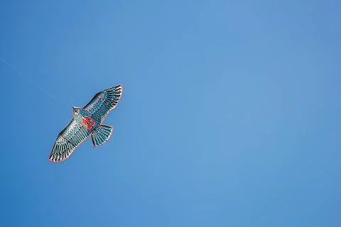 Flying kite in blue sky Stock Photos