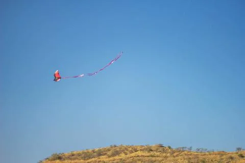 Flying kite in blue sky Stock Photos