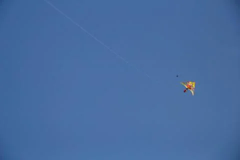 Flying kite in blue sky Stock Photos