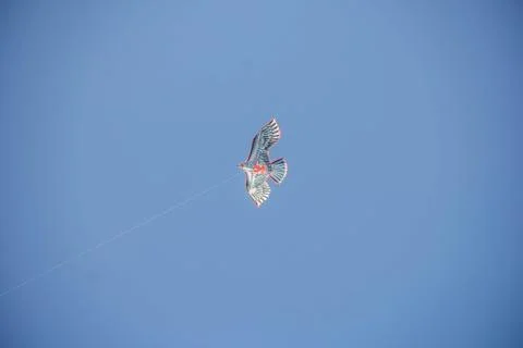Flying kite in blue sky Stock Photos