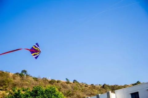 Flying kite in blue sky Stock Photos