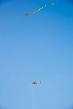 Flying kite in blue sky Stock Photos