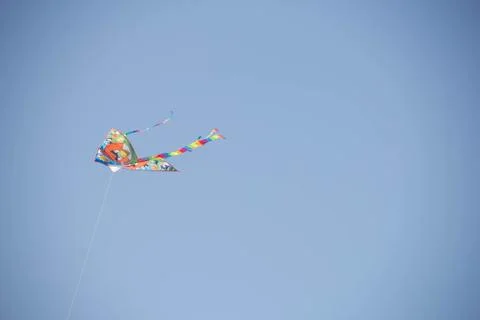 Flying kite in blue sky Stock Photos