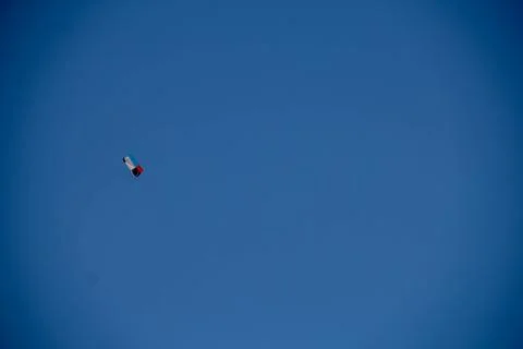 Flying kite in blue sky Stock Photos