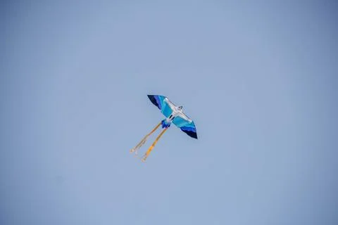 Flying kite in blue sky Stock Photos