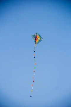 Flying kite in blue sky Stock Photos
