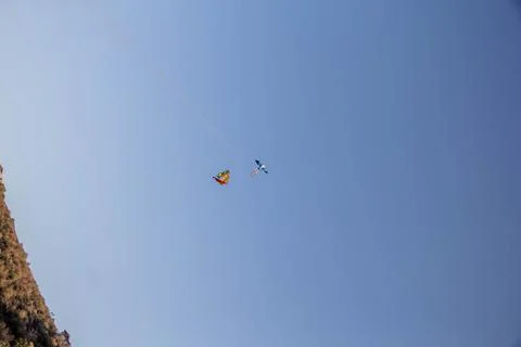 Flying kite in blue sky Stock Photos