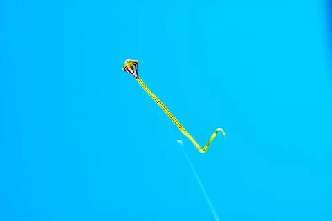 Flying kite in blue sky Stock Photos