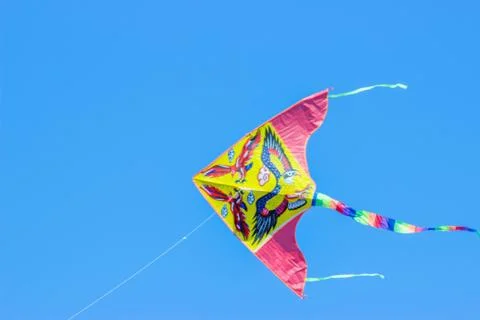 Flying kite in blue sky Stock Photos