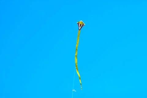 Flying kite in blue sky Stock Photos